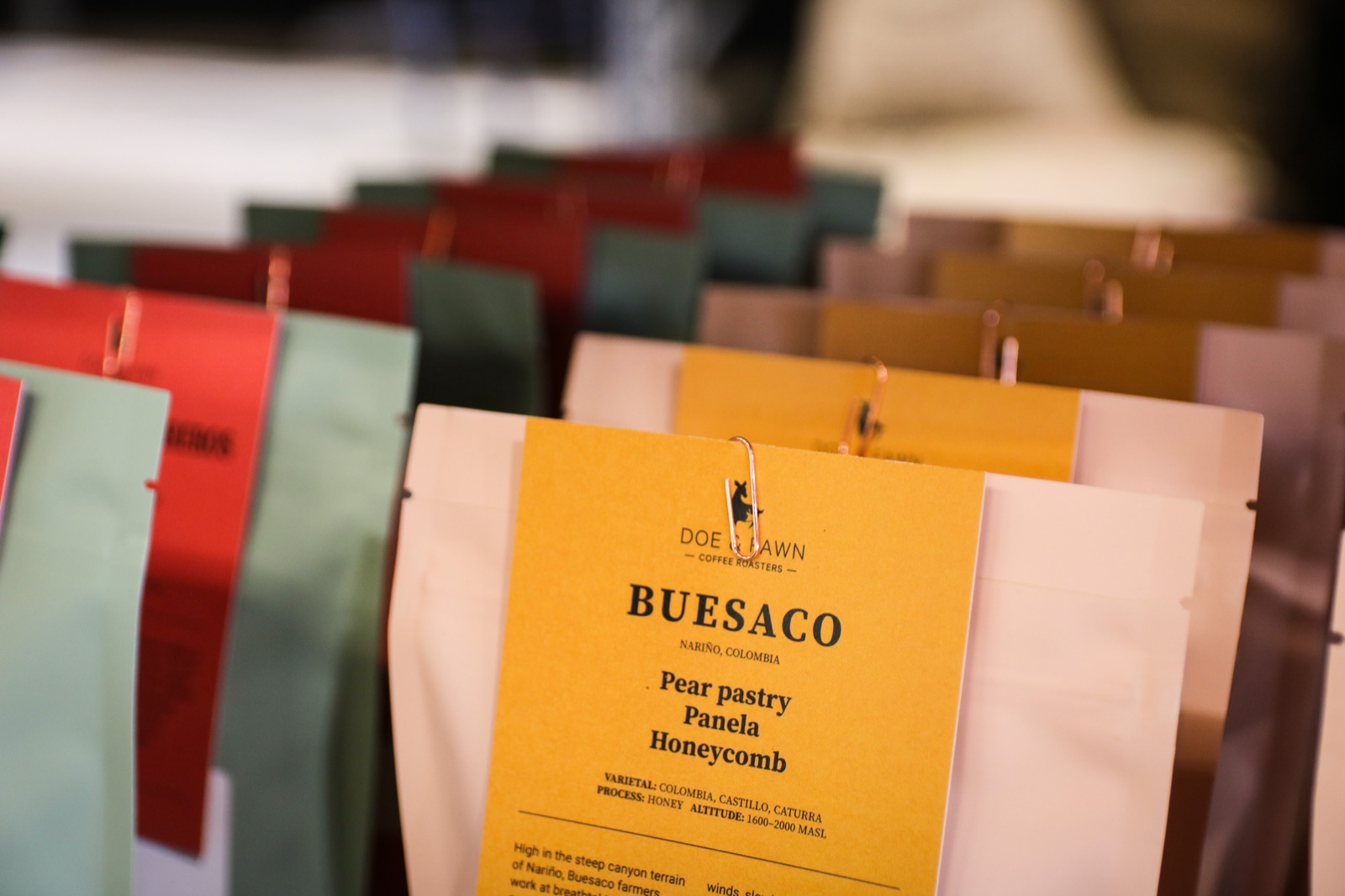 Doe & Fawn coffee bags lined up at the roastery
